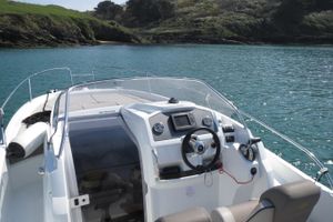 Jeanneau Cap Camarat 7.5 WA 2015 Jeanneau Cap Camarat 7.5 WA boat on calm water near rocky shoreline.
