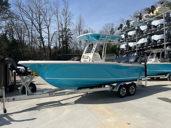 Key West 239 FS 2024 Key West 239 FS boat in vibrant blue on a trailer, parked outdoors.