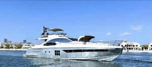 Azimut 77S 2015 Azimut 77S yacht cruising on a sunny day near luxury waterfront homes.