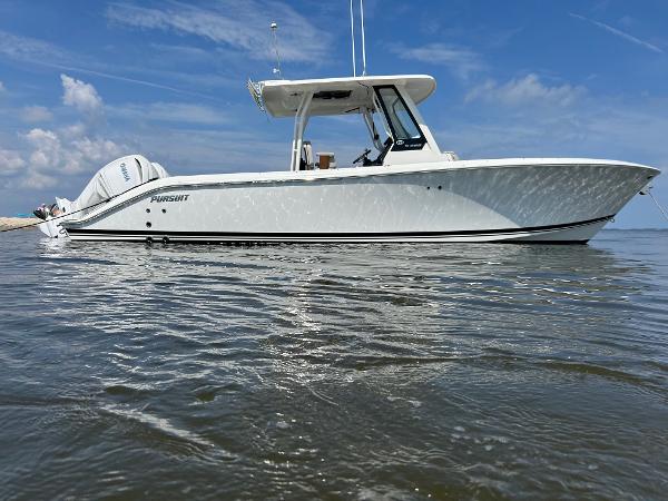 Pursuit S 288 Sport 2023 Pursuit S 288 Sport boat on calm water under a clear blue sky.