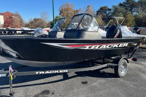 Tracker Pro Guide V-16 WT 2026 Tracker Pro Guide V-16 WT boat on trailer, black with red accents, parked outdoors.