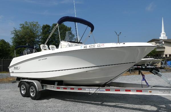 Boston Whaler 220 Outrage 2011 Boston Whaler 220 Outrage boat on trailer, parked outdoors.