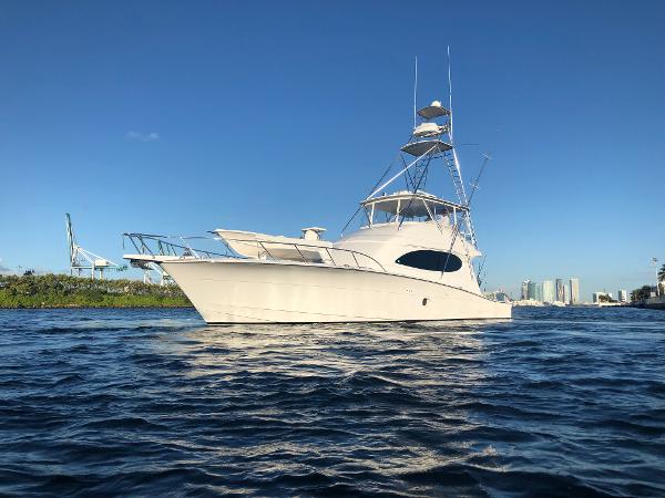 Hatteras 64 Convertible 2006 Hatteras 64 Convertible yacht on calm water under clear blue sky.
