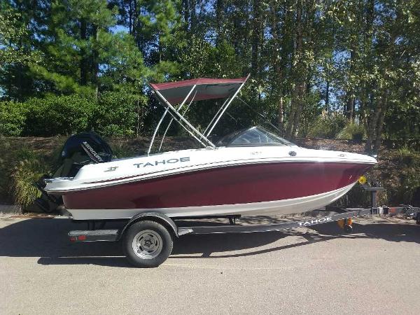 Tahoe 185 S 2024 Tahoe 185 S boat on trailer, red and white, parked outdoors.