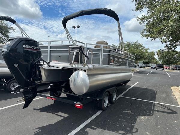 Sun Tracker Fishin' Barge 20 DLX 2024 Sun Tracker Fishin' Barge 20 DLX pontoon boat in parking lot.