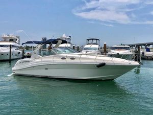 Sea Ray 340 Sundancer 2005 Sea Ray 340 Sundancer yacht docked in a marina under a clear blue sky.