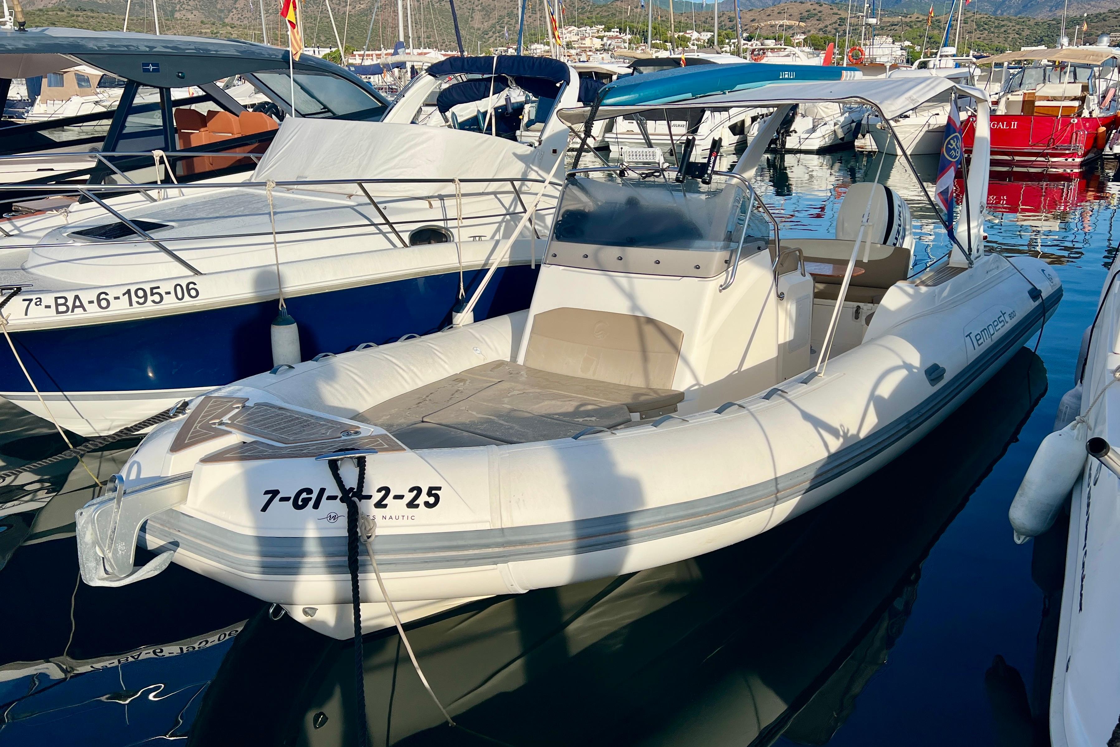Capelli Tempest 800 2015 Capelli Tempest 800 boat docked in a marina, surrounded by other vessels.