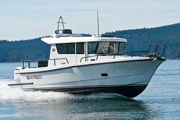 Sargo 31OB 2025 Sargo 31OB boat cruising on a calm lake with forested hills in the background.