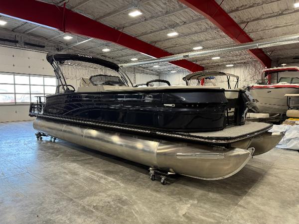Sylvan G5 DLZ DH 2025 Sylvan G5 DLZ DH pontoon boat in showroom, black exterior, under bright lighting.