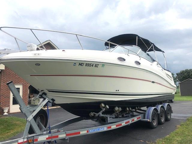 Sea Ray 260 Sundancer 2008 Sea Ray 260 Sundancer boat on trailer, parked outdoors.