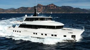 Gulf Craft Nomad 95 Luxurious 2021 Gulf Craft Nomad 95 yacht cruising on open sea with scenic mountain backdrop.