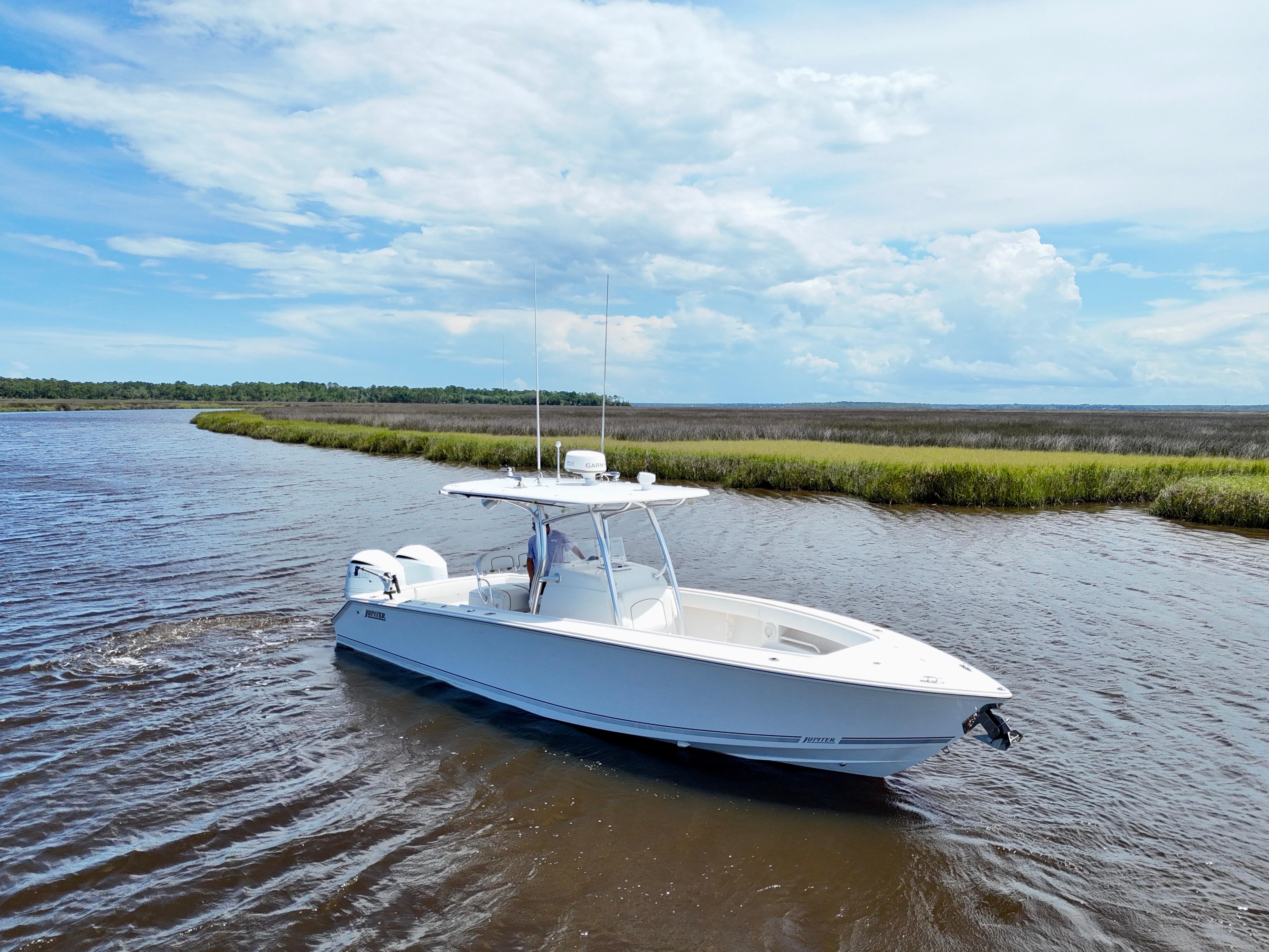 Jupiter 30 FS 2013 Jupiter 30 FS boat cruising on a scenic river under a blue sky.
