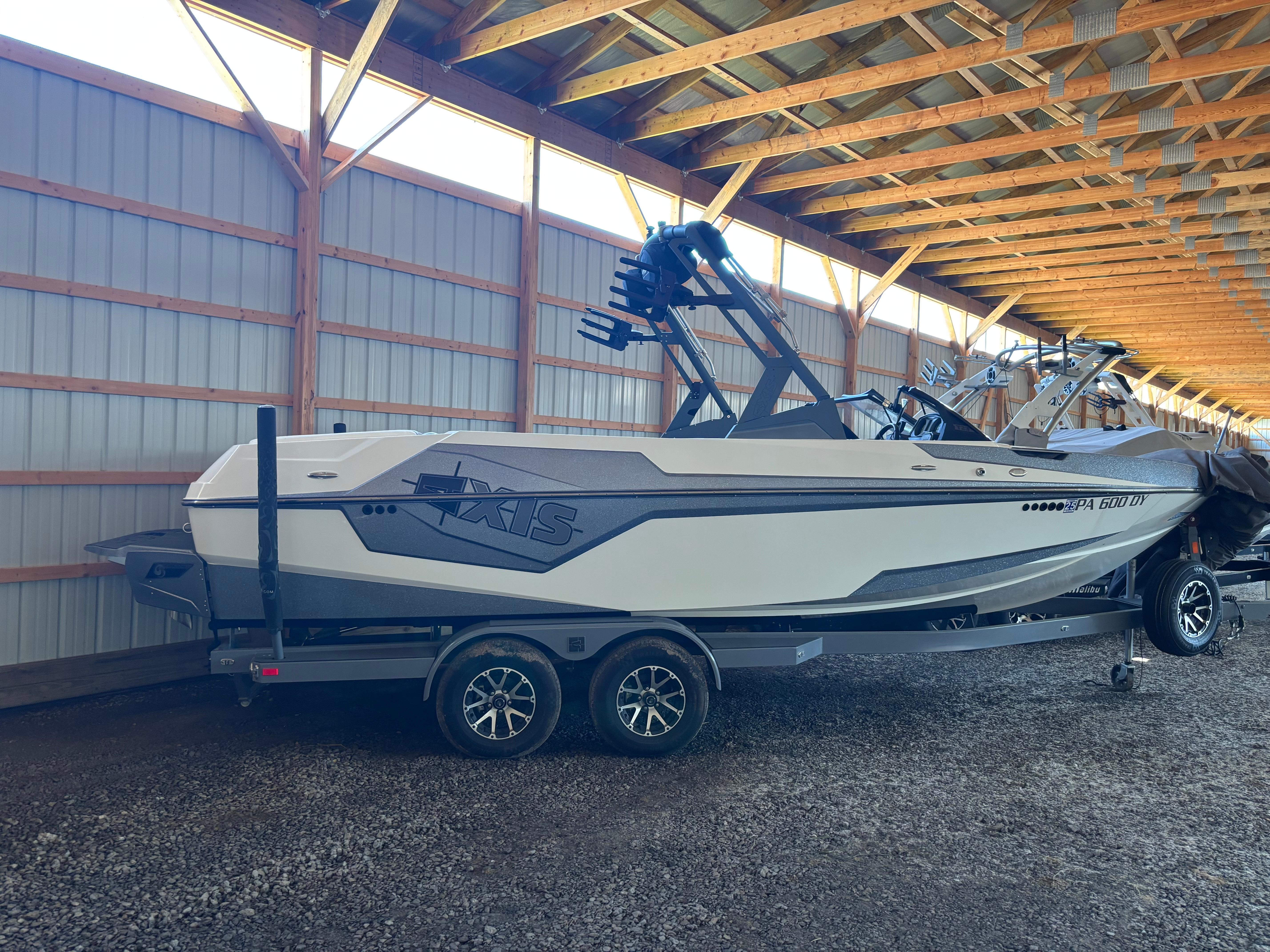 Axis T23 2020 Axis T23 boat on trailer in covered storage facility.