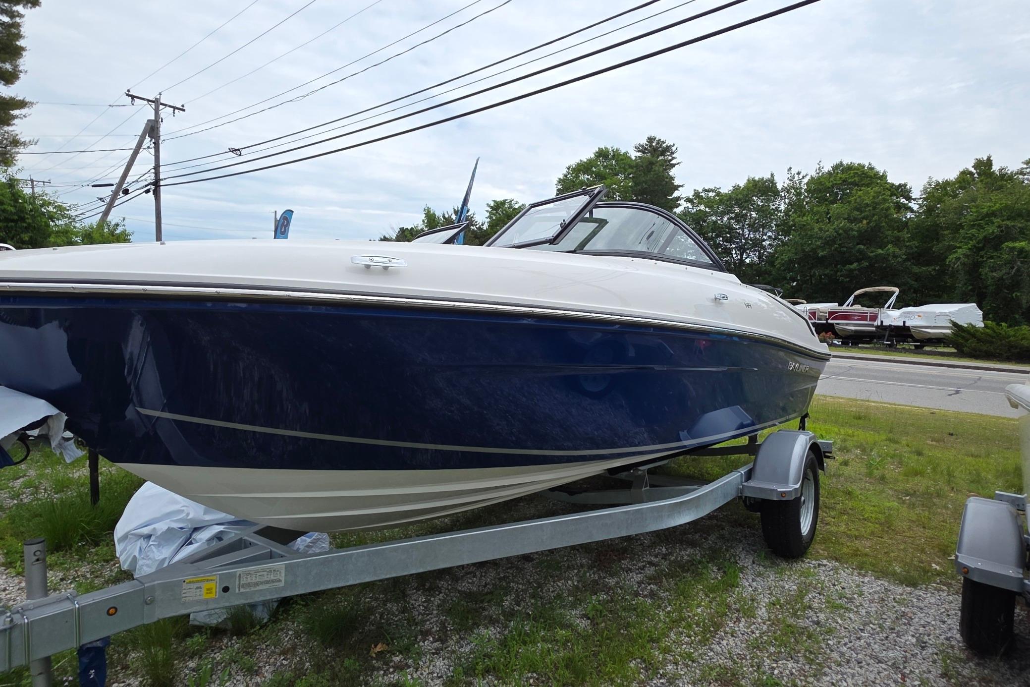 Bayliner VR4 Bowrider OB 2025 Bayliner VR4 OB boat on trailer, parked outdoors, showcasing sleek design and blue hull.