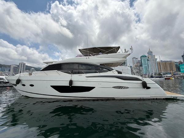 Princess S72 2016 Princess S72 yacht docked in a city marina under cloudy skies.