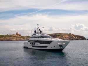 Custom Line 106 Luxurious 2019 Custom Line 106 yacht cruising near scenic rocky coastline.