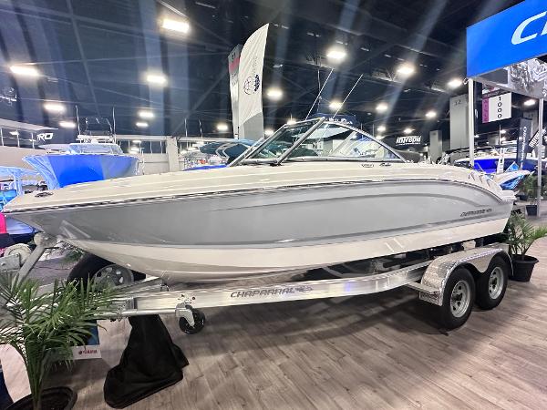 Chaparral 19 SSi 2024 Chaparral 19 SSi boat displayed indoors on a trailer at a boat show.