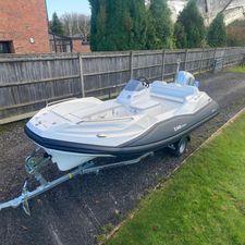 Zar Formenti ZF-5 2024 Zar Formenti ZF-5 boat on trailer, parked outdoors near wooden fence.
