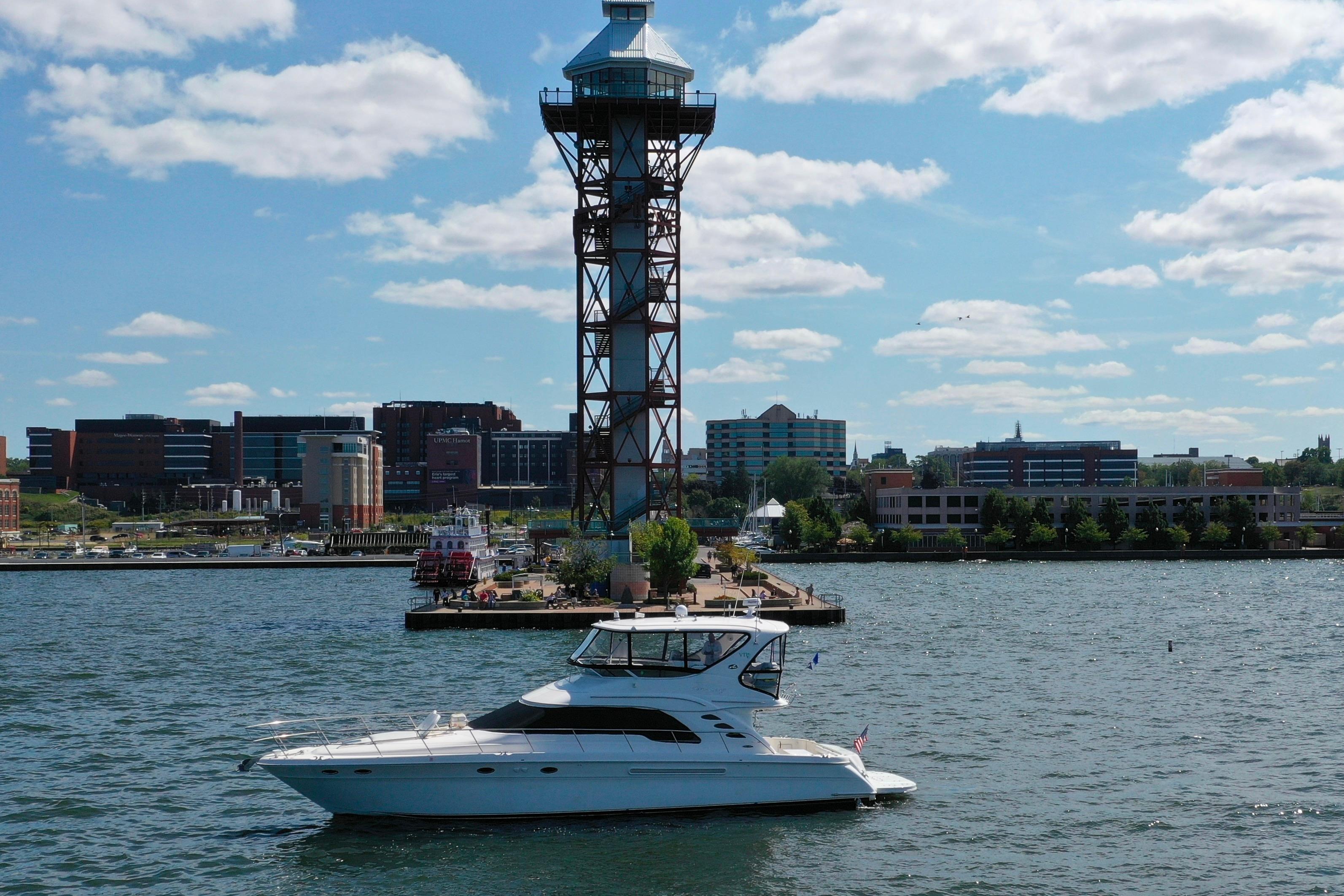 Sea Ray 550 Sedan Bridge 2002 Sea Ray 550 Sedan Bridge yacht on water near urban skyline and tower.