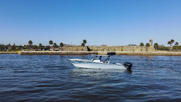 Front Runner 39 Center Console 2026 Front Runner 39 CC boat on water near historic fort and palm trees.