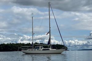 Camper & Nicholsons Center Cockpit 1974 Camper & Nicholsons Center Cockpit sailboat on calm water under cloudy sky.