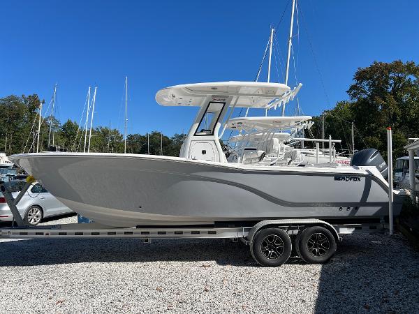 Sea Fox 248 Commander 2025 Sea Fox 248 Commander boat on trailer, parked outdoors under clear blue sky.