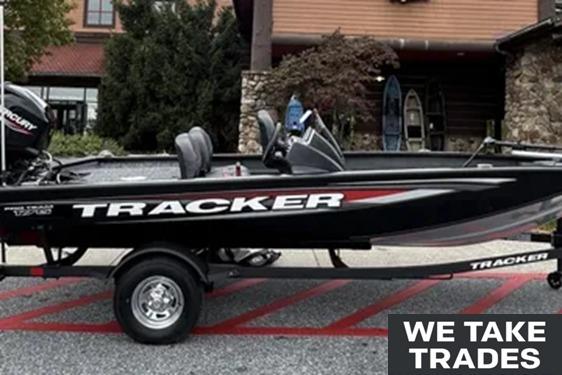 Tracker Pro Team 175 Crappie Edition 2026 Tracker Pro Team 175 Crappie Edition boat on trailer, "We Take Trades" sign visible.