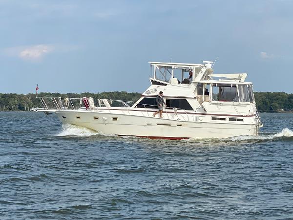 Viking 44 Motor Yacht 1986 Viking 44 Motor Yacht cruising on a lake with clear skies.