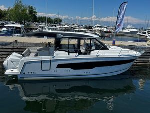 Jeanneau NC 895 2025 Jeanneau NC 895 boat docked at marina, clear sky, calm water.