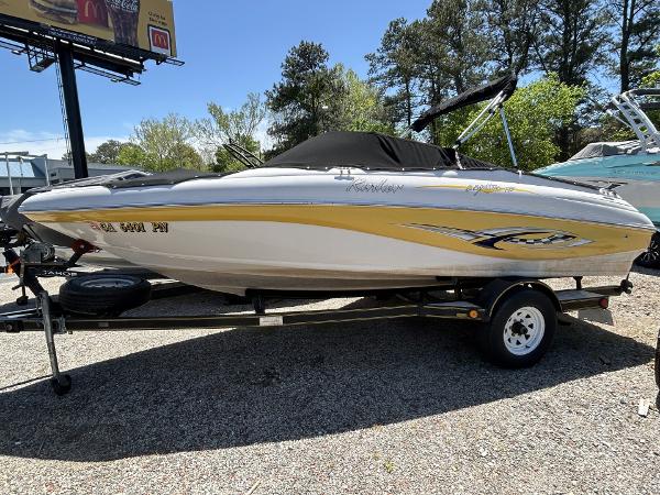 Rinker 192 Captiva 2004 Rinker 197 Captiva boat on trailer, parked outdoors under clear sky.