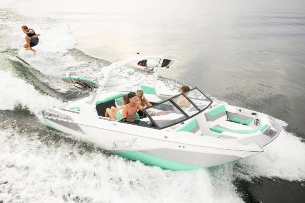 ATX Surf Boats 20 Type-S 2025 ATX Surf Boats 20 Type-S cruising with wakeboarder, featuring sleek design and vibrant colors.