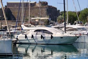 Enterprise Marine 43 FLY 2004 Enterprise Marine 43 FLY yacht docked in a marina with historic fort backdrop.