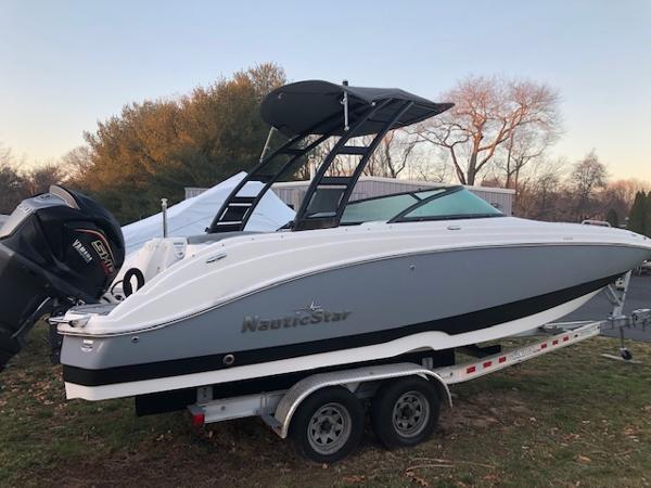 NauticStar 243DC Sport Deck 2023 NauticStar 243DC Sport Deck boat on a trailer, side view.