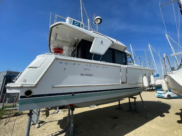 Beneteau Swift Trawler 30 2018 Beneteau Swift Trawler 30 on dry dock under clear blue sky.