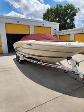 Sea Ray Signature 2000 Sea Ray Signature boat on trailer, parked near yellow storage units.