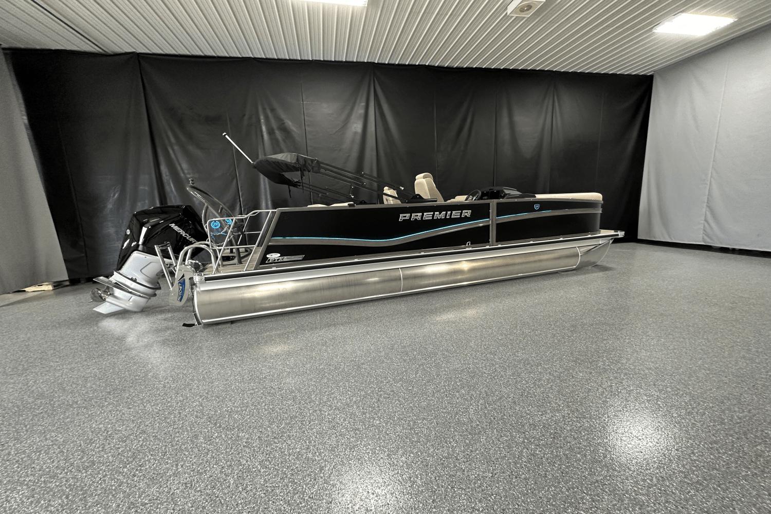 Premier 230 Solaris 2024 Premier 230 Solaris pontoon boat in showroom with sleek design and modern features.