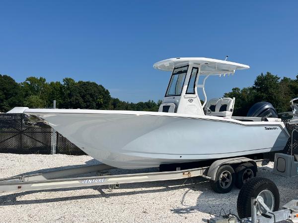 Tidewater 232 LXF 2025 Tidewater 232 LXF boat on trailer, sleek design, white hull, outdoor setting.