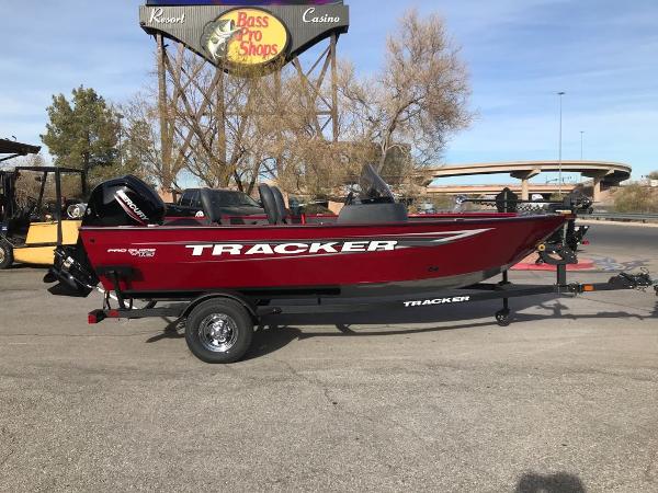 Tracker Pro Guide V-16 SC 2025 Tracker Pro Guide V-16 SC boat in a parking lot near Bass Pro Shops.