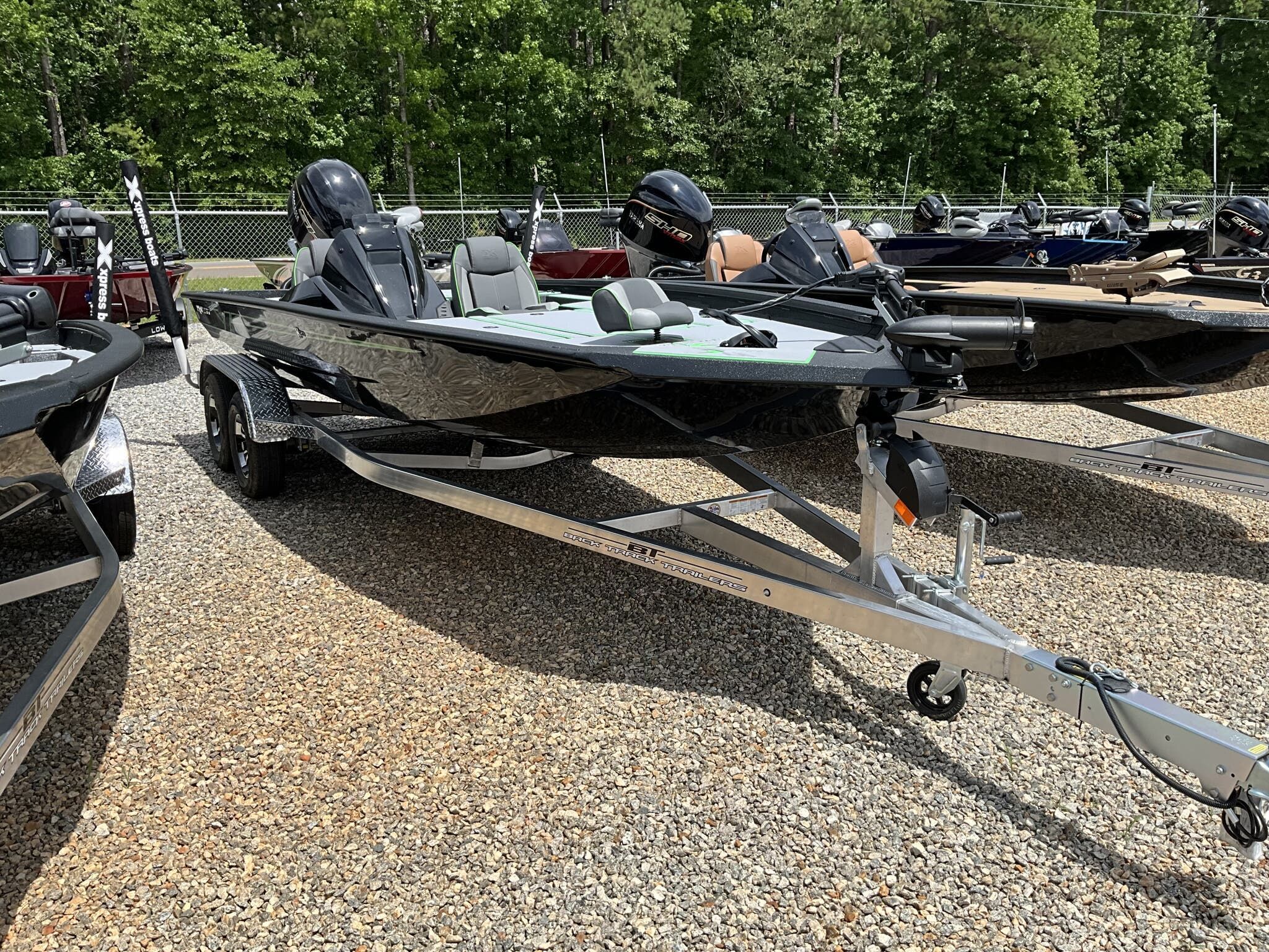 Xpress Hyper-Lift Bass Series H20 2026 Xpress Hyper-Lift Bass Series H20 boat on trailer, parked outdoors.