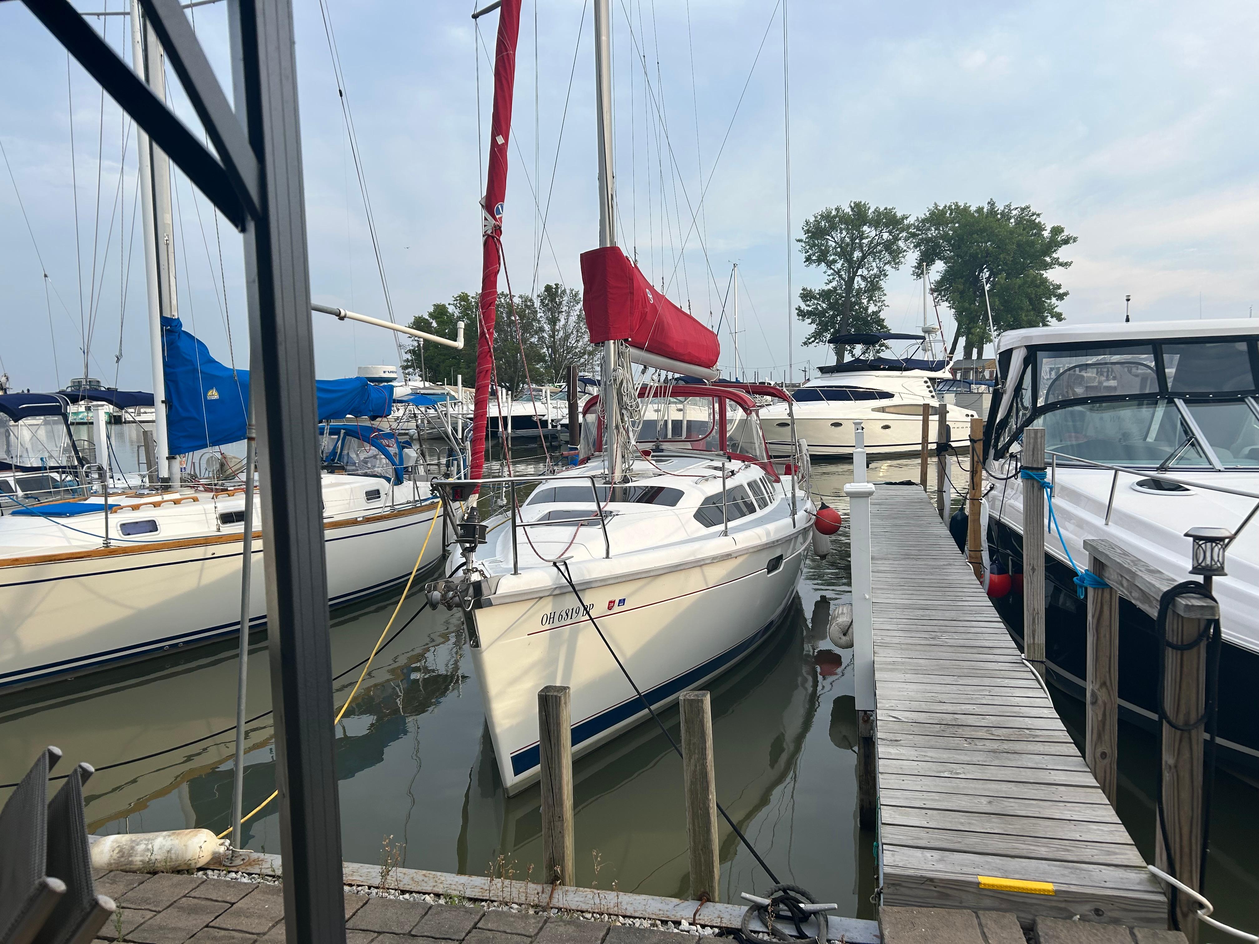 Hunter 336 Sailboat docked at marina, Hunter 336 model, 1996, with red sail cover.