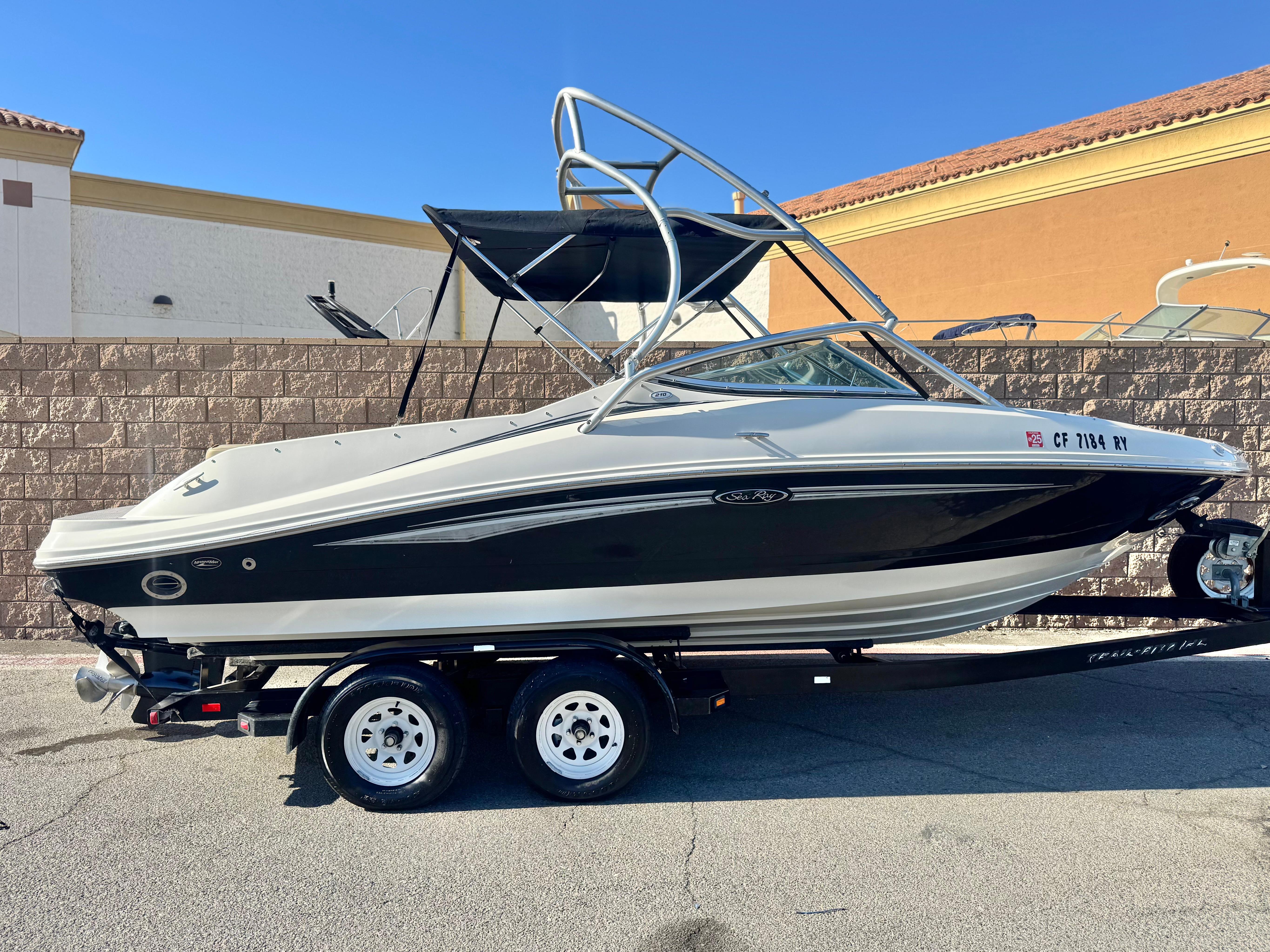 Sea Ray 210 Select 2007 Sea Ray 210 Select boat on trailer, parked outdoors.