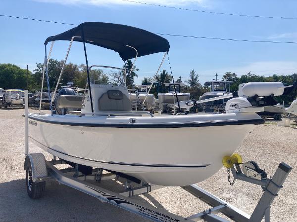 Key West 1720 Cc 2025 Key West 1720CC boat on trailer with canopy, parked outdoors.