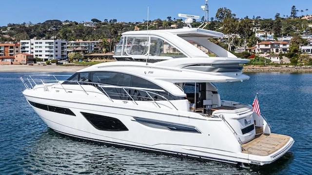 Princess F55 Luxurious 2022 Princess F55 yacht cruising near scenic coastline.
