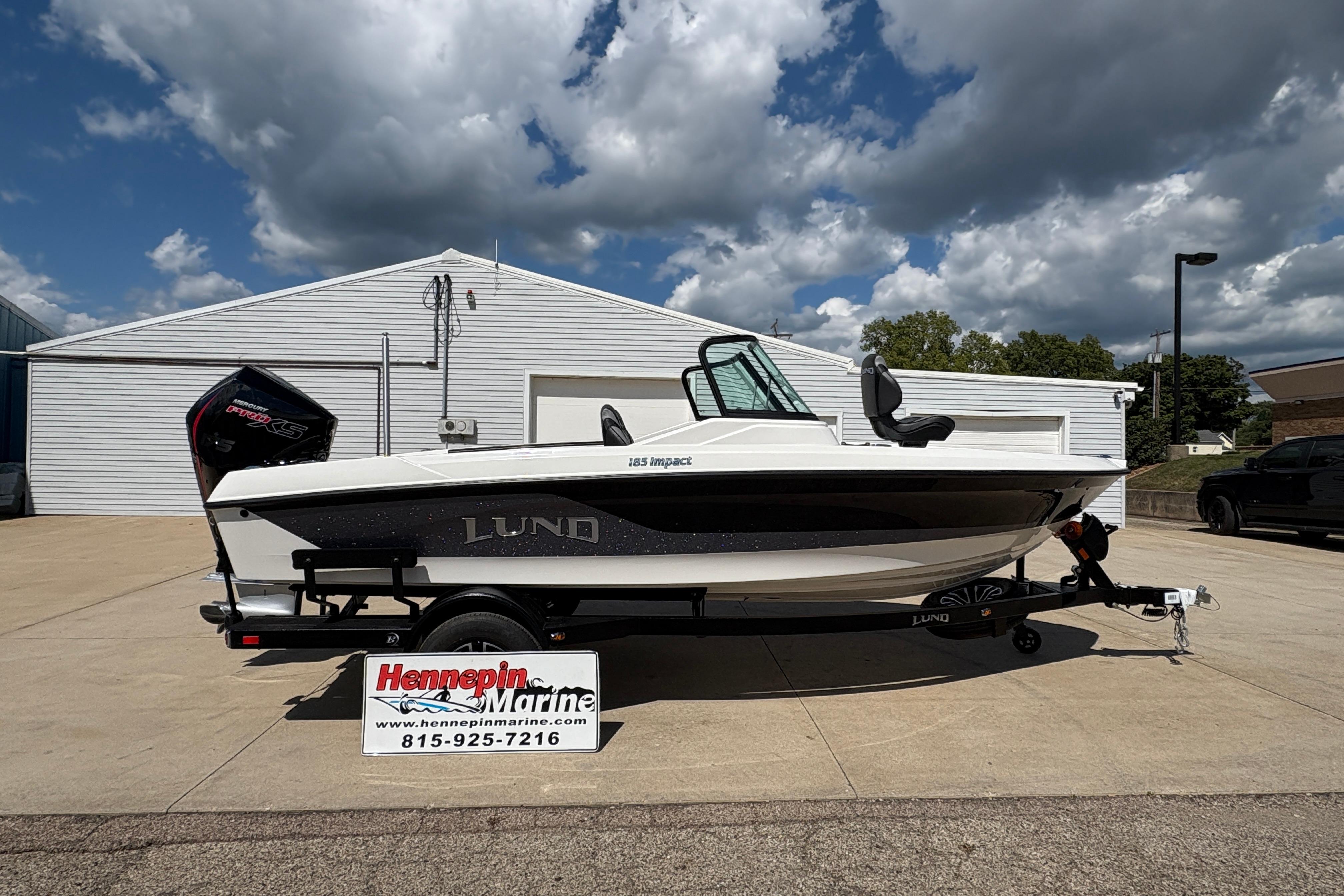 Lund 185 Impact GL 2026 Lund 185 Impact GL boat on trailer at Hennepin Marine dealership.