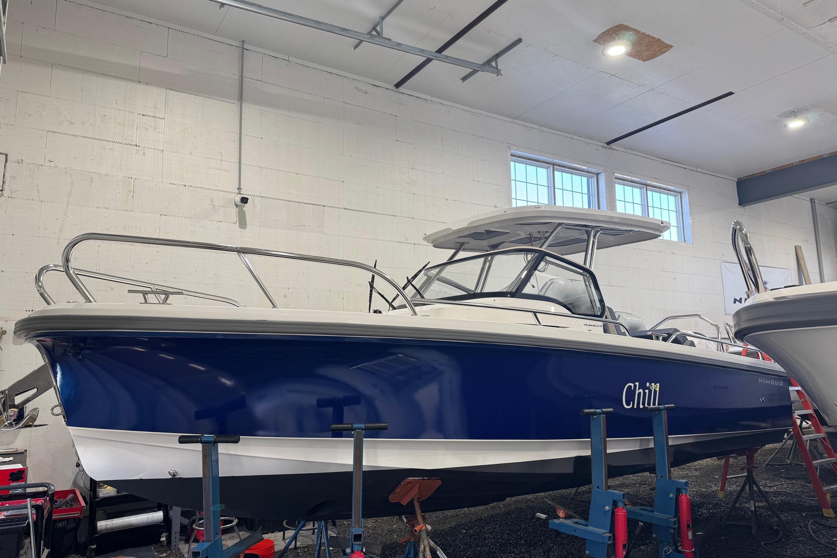 Nimbus Tender 8 2025 Nimbus Tender 8 boat in a garage, blue hull, labeled "Chill."