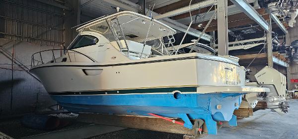 Pursuit 3800 Express 2002 Pursuit 3800 Express boat in storage, featuring a blue hull and white cabin.
