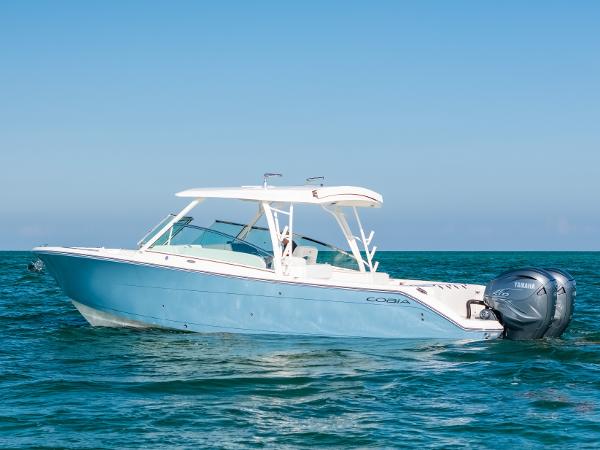 Cobia 330 Dual Console 2024 Cobia 330 Dual Console boat on open water, side view.