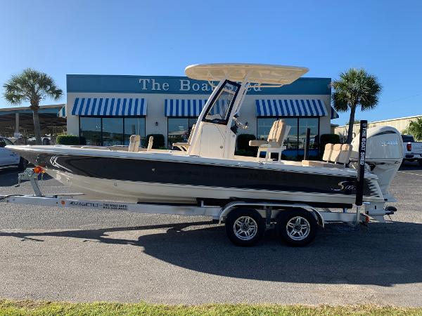 Scout 231 XSB 2025 Scout 231 XSB boat on trailer outside dealership.
