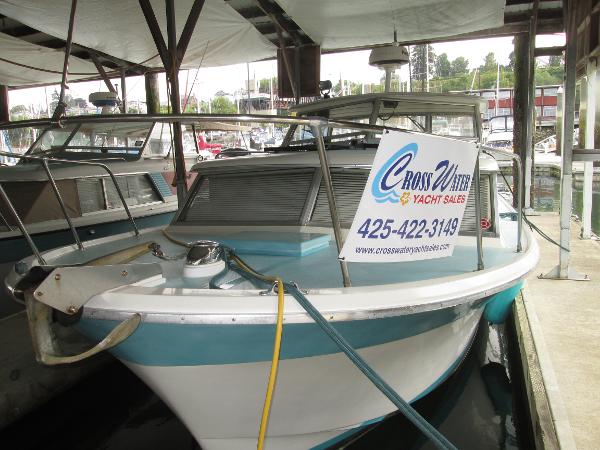 Tollycraft 28 1970 Tollycraft 28 boat docked, featuring Crosswater Yacht Sales sign.