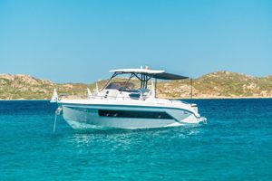 Ranieri 330 NEXT LX 2023 Ranieri 330 NEXT LX boat anchored in clear blue water, scenic coastal backdrop.